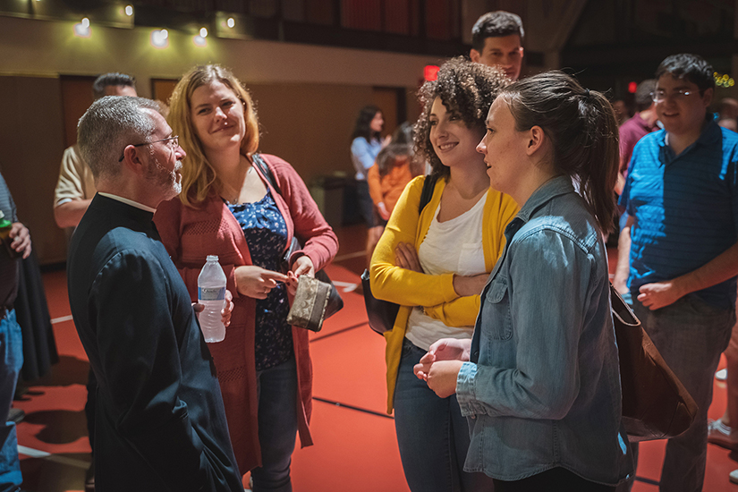 Father Donald J. Planty Jr., pastor of St. Charles Borromeo Church in Arlington, Va., chatted with young people in an undated photo during a P3 evangelization event in the parish gym.
