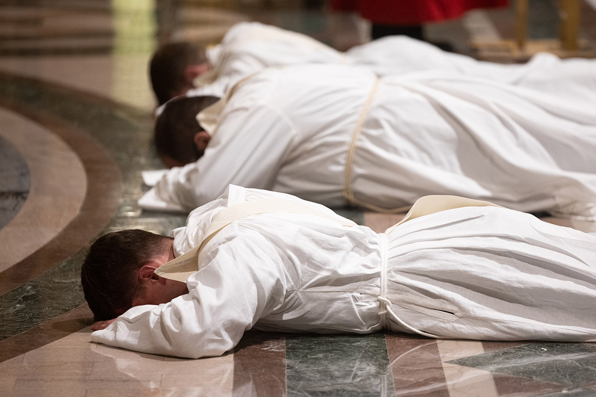 Fathers Joseph Martin, Robert Lawson and Jeffrey Fennewald lay prostrate during the litany of supplication during the Rite of Ordination to the Priesthood on May 25 at the Cathedral Basilica of Saint Louis.