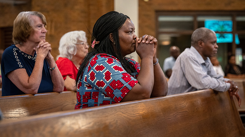 Jane Kariuki prayed during a Mass in Swahili Sept. 4, 2022, at St. Norbert Church in Florissant.
