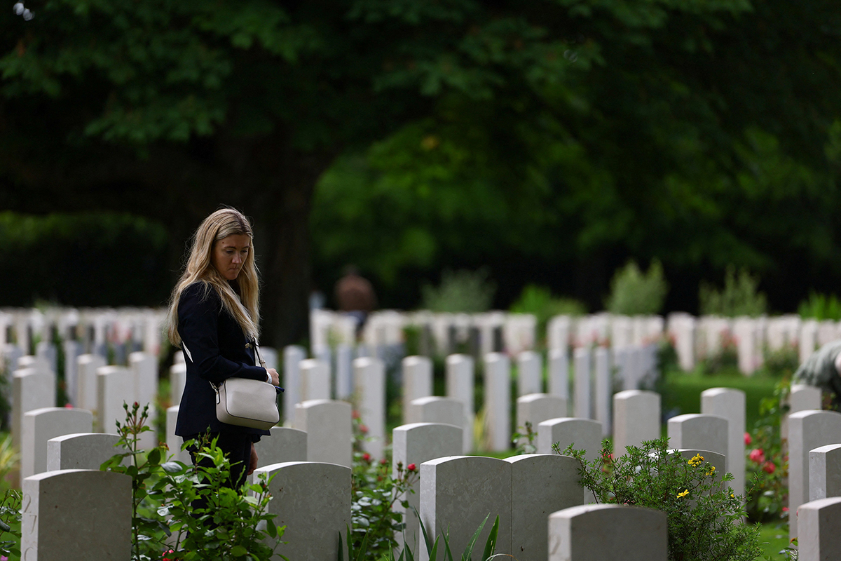 A woman looked at graves at Bayeux cemetery, a British military cemetery in Normandy, on June 5. Several commemorative events took place that day for the 80th anniversary of D-Day, June 6, 1944.