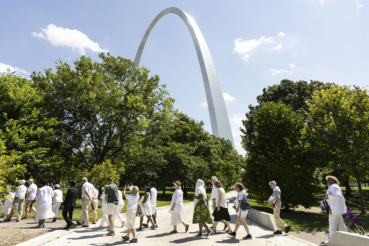 Participants walked past the Gateway Arch during the the third annual Forgive Us Our Trespasses prayer service and Maafa procession in Downtown St. Louis. The gathering commemorates the approximately 2 million lives lost during the Middle Passage of the Atlantic slave trade.